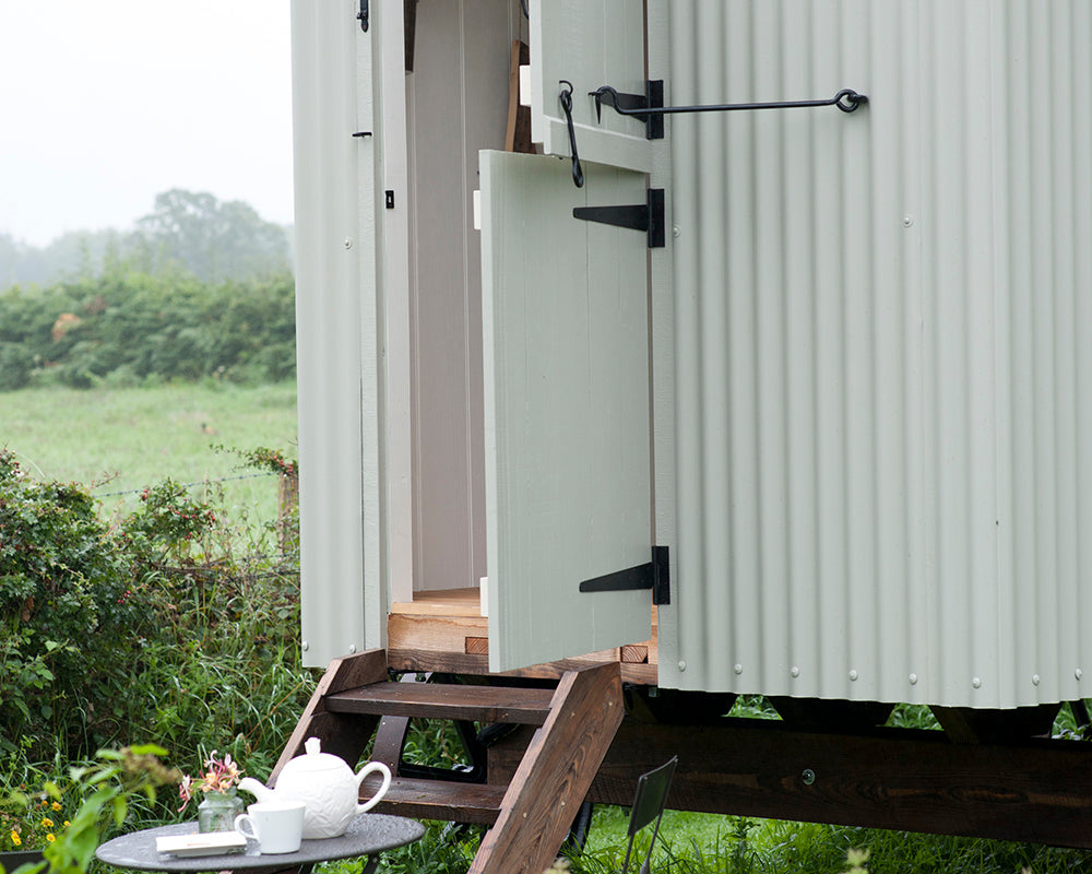Blue Gray 91 paint by Farrow & Ball on the cladding of a shepherds hut