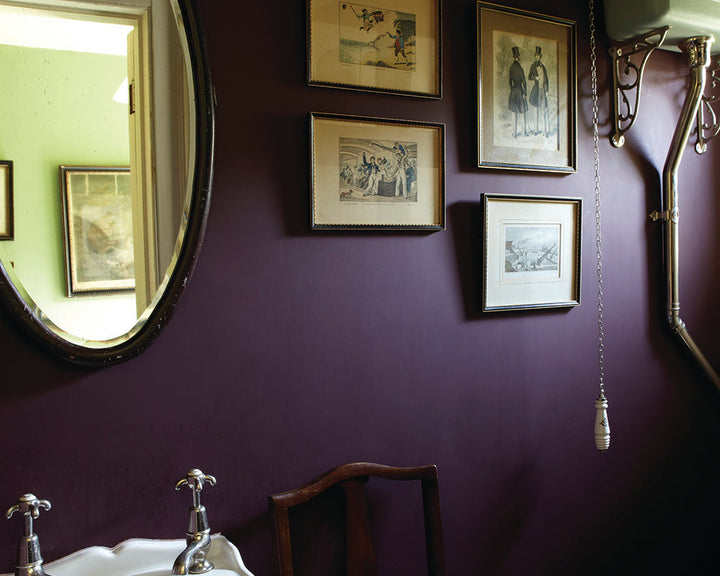 Brinjal 222 paint by Farrow & Ball on the walls of a bathroom with artwork
