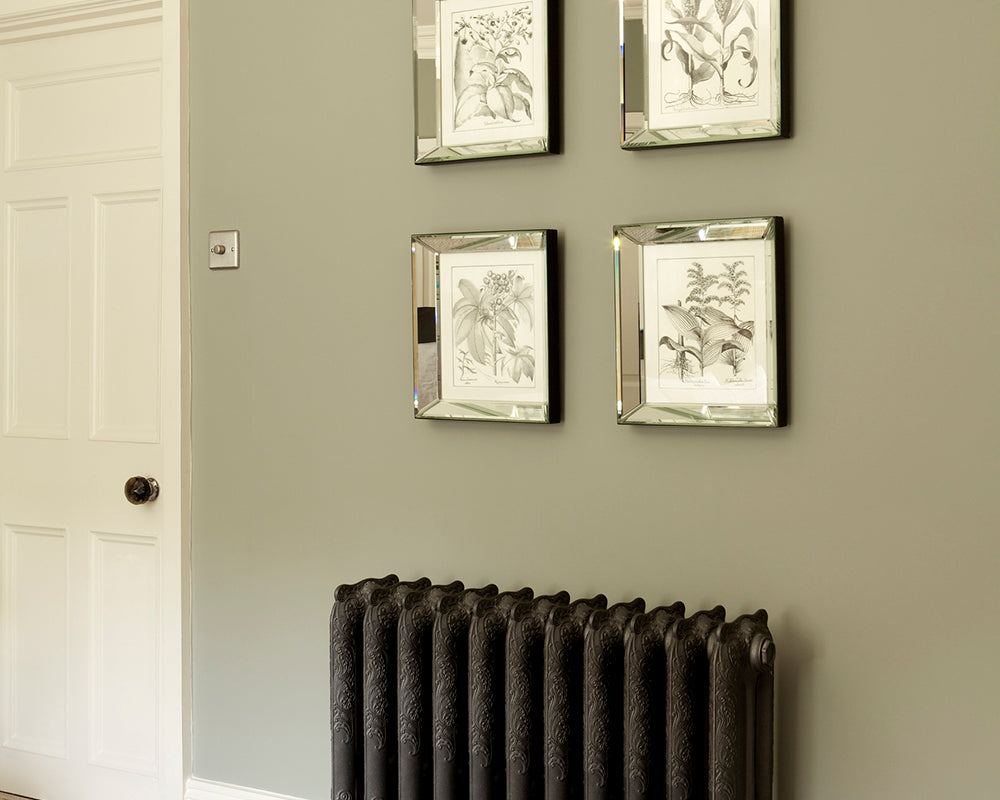 Pigeon 25 paint by Farrow & Ball in a room with artwork and a radiator