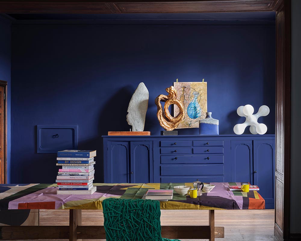 Blue Maize CB11 paint by Farrow & Ball in a living space filled with art and sculptures