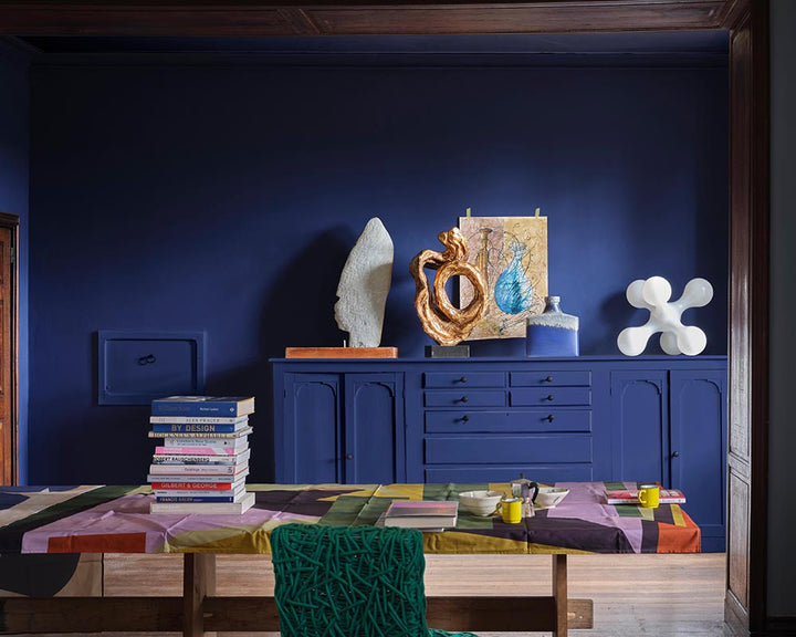 Blue Maize CB11 paint by Farrow & Ball in a living space filled with art and sculptures