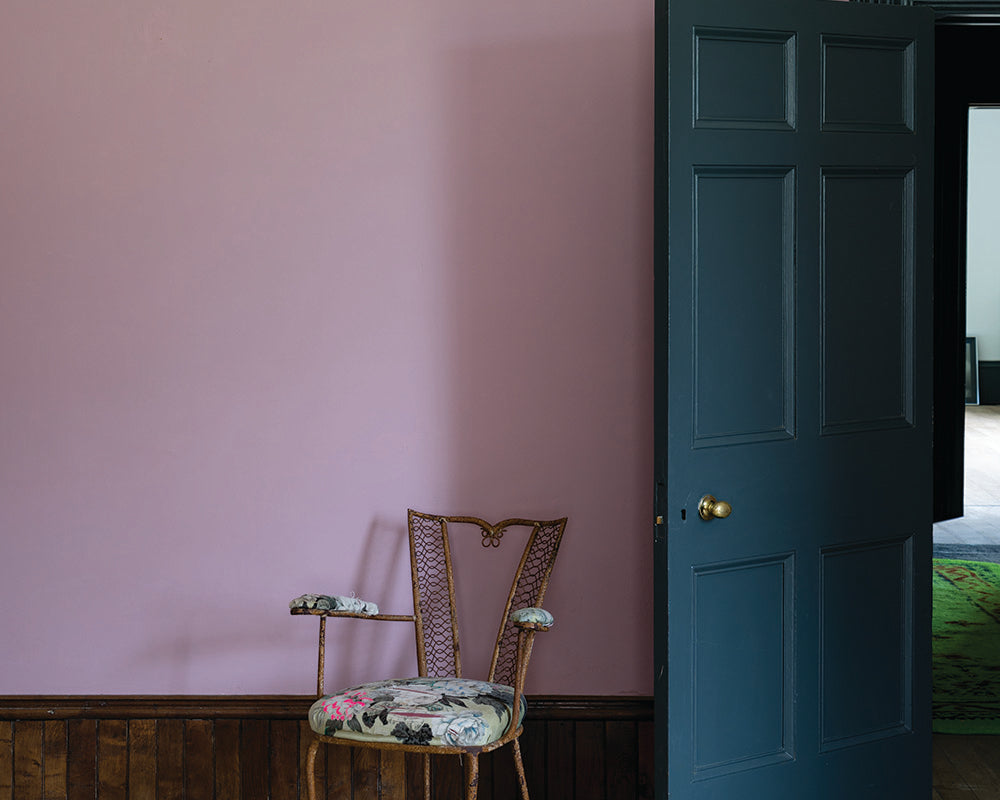 Cinder Rose 246 paint by Farrow & Ball on a living room wall with dark woodwork