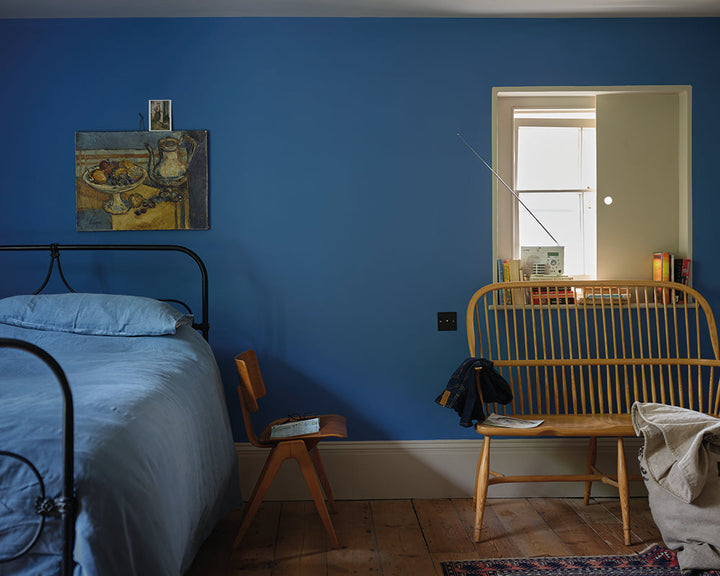 Ultra Marine Blue W29 paint by Farrow & Ball in a cosy bedroom