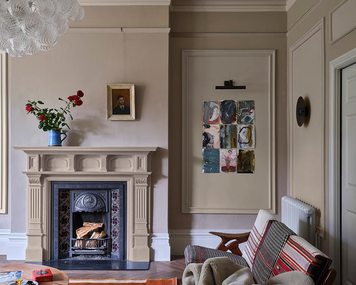 Stirabout 300 paint by Farrow & Ball in a living room with bold artwork and traditional fireplace