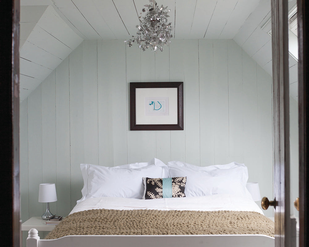 Cabbage White 269 paint by Farrow & Ball used on cladding in a cottage bedroom