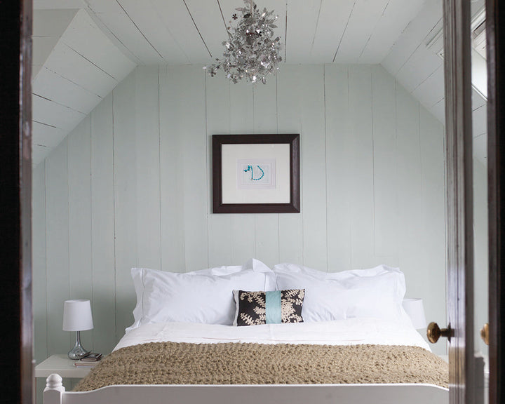 Cabbage White 269 paint by Farrow & Ball used on cladding in a cottage bedroom
