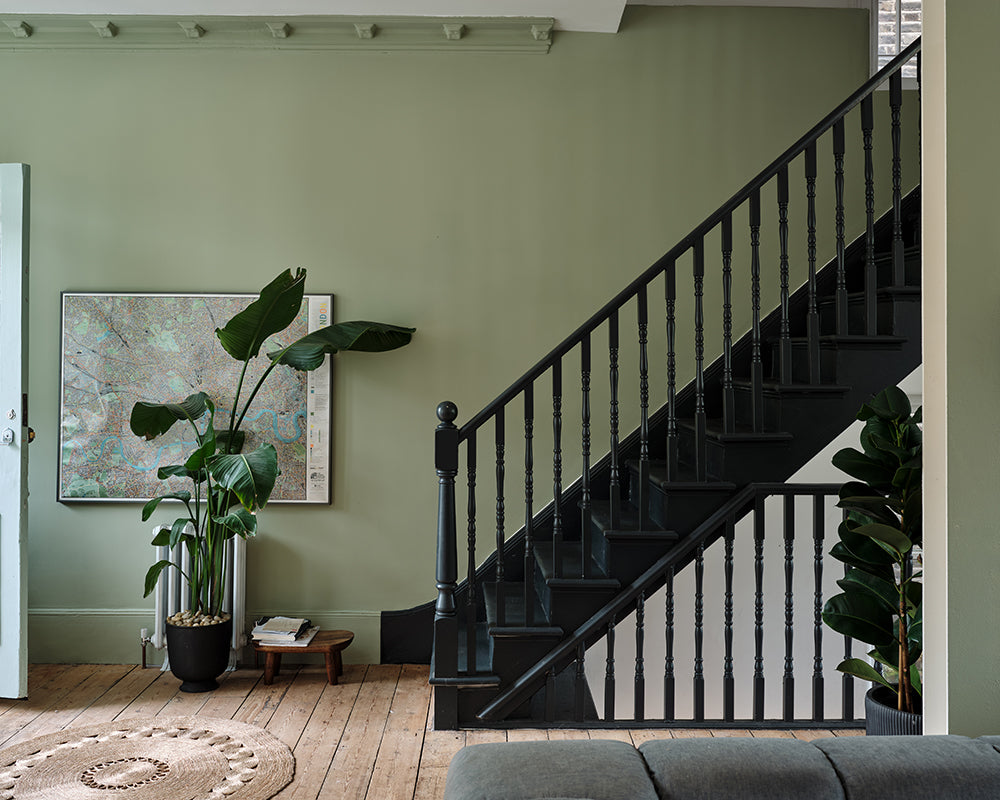 Studio Green 93 paint by Farrow & Ball on the banister and spindles in a hallway