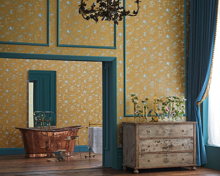 Cole & Son Hummingbirds Wallpaper in Ice Blue on Metallic Gold in a bedroom set up