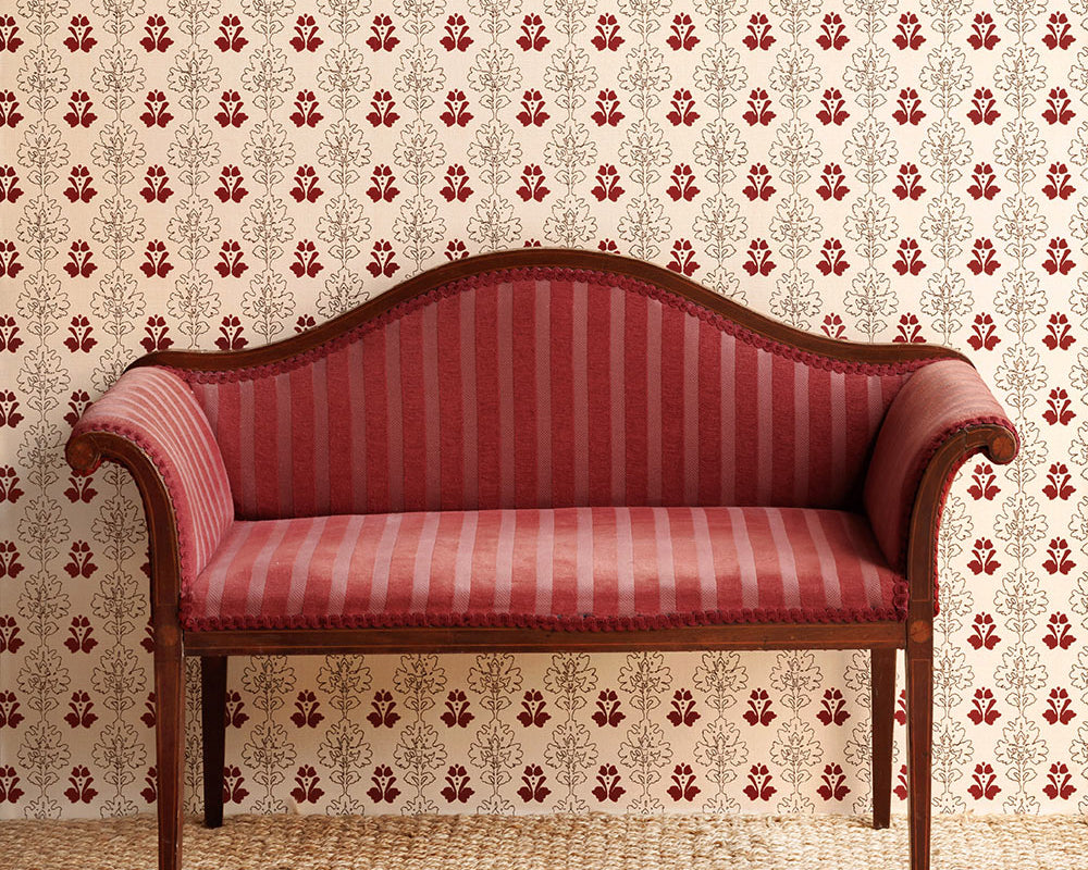 Barneby Gates Floral Block Wallpaper in a room with an antique sofa