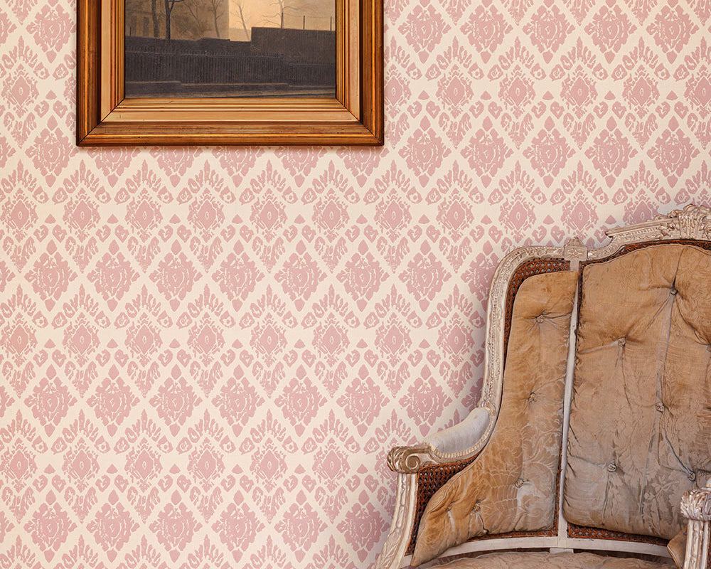 Barneby Gates Ikat Wallpaper in a room with a chair and a frame on the wall