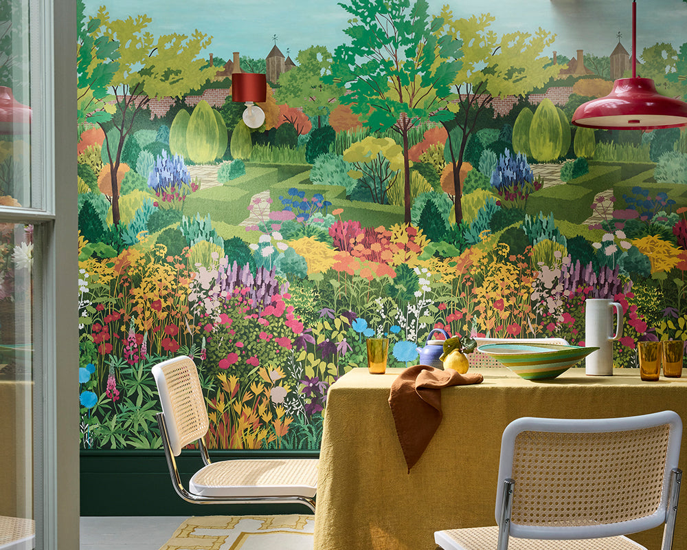Dining area with a colorful Little Greene Castle Garden Mural Wallpaper on the wall.