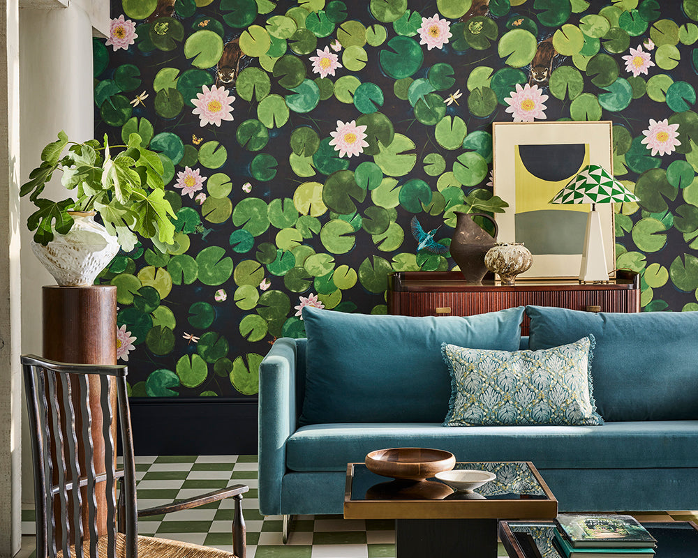 Living room with teal sofa, decorative Little Greene Lily Pads Mural Wallpaper, and plants