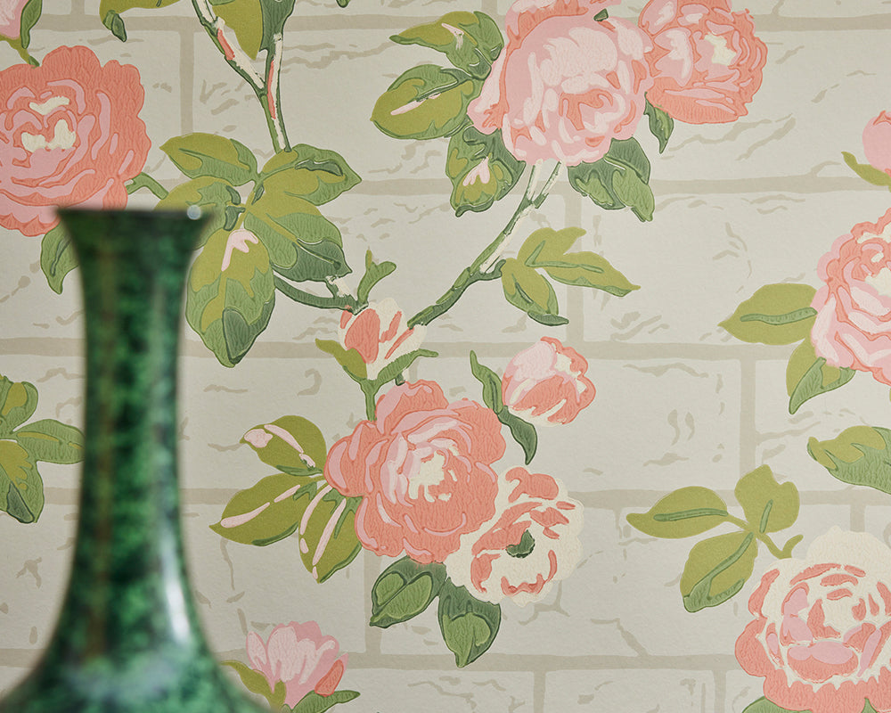 Little Greene Rose Garden Floral wallpaper with pink roses and green leaves, featuring a green vase in the foreground.