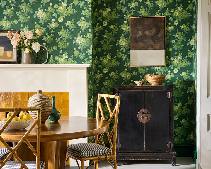 Dining room with Little Greene Rose Garden floral wallpaper, wooden table, and chairs.