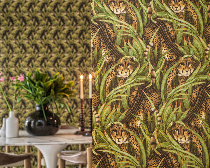 Cole & Son Cheetah Prowl Wallpaper with cheetah and leaf pattern in a room with a table and candles.