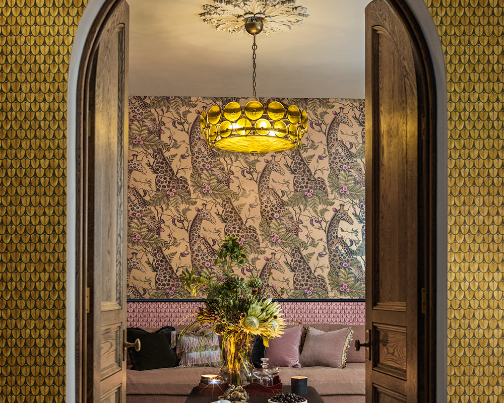 Decorative interior with patterned Cole & Son Narina Wallpaper, chandelier, and furniture.