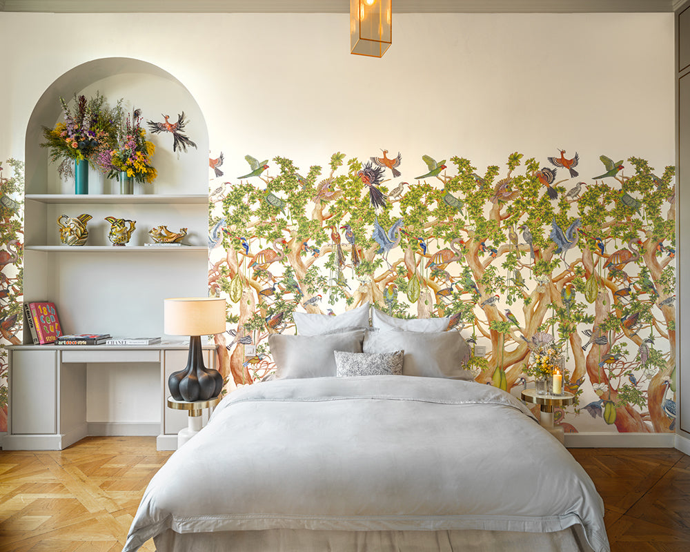 Decorative wall mural Cole & Son Tree of Life Wallpaper with trees and birds in a bedroom setting.