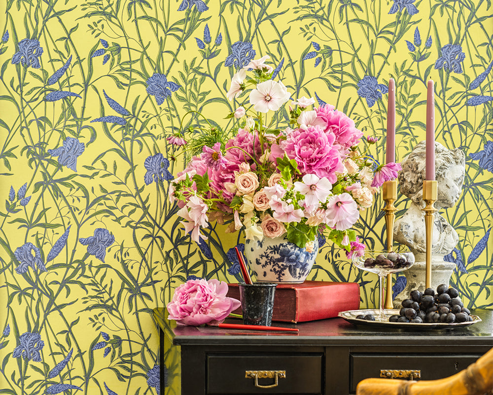 Decorative table setting with flowers and candles against the floral Cole & Son Iris Wallpaper