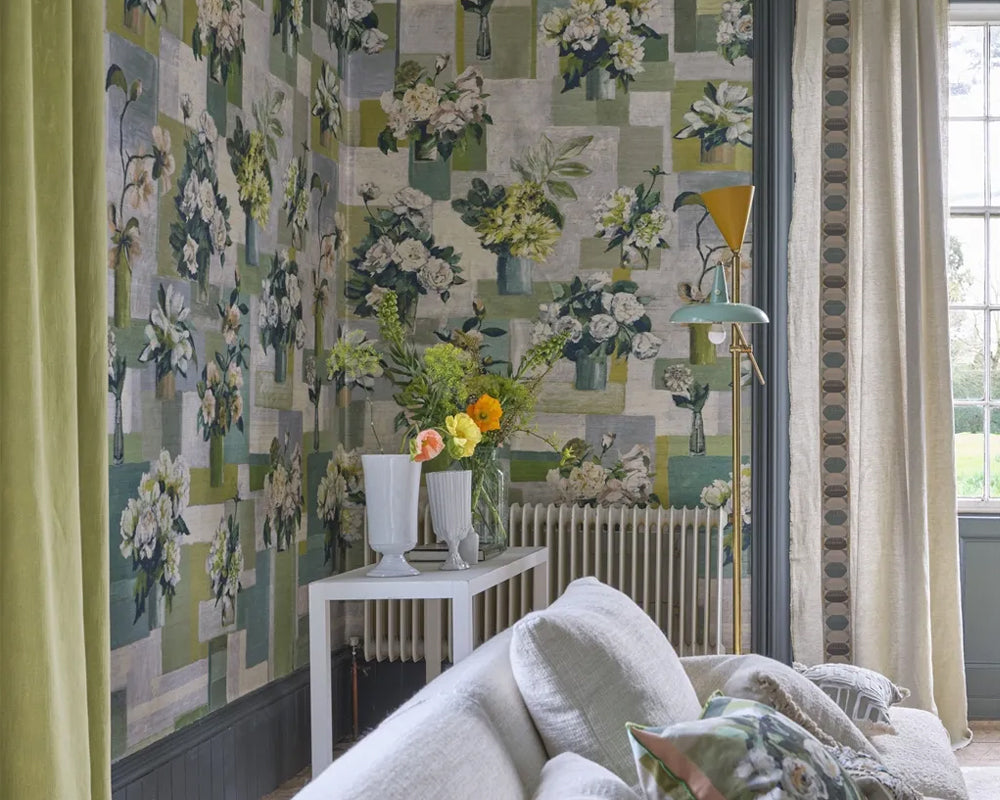 Living room with floral wallpaper, Designers Guild Celadon Vase, on a natural Grasscloth, a white sofa, and decorative elements.