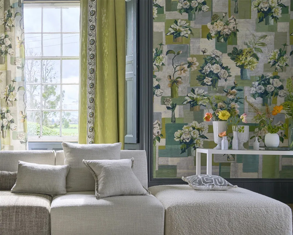 Living room with floral wallpaper, Designers Guild Celadon Vase Wallpaper - Grasscloth, soft grey sofa, and decorative pillows.