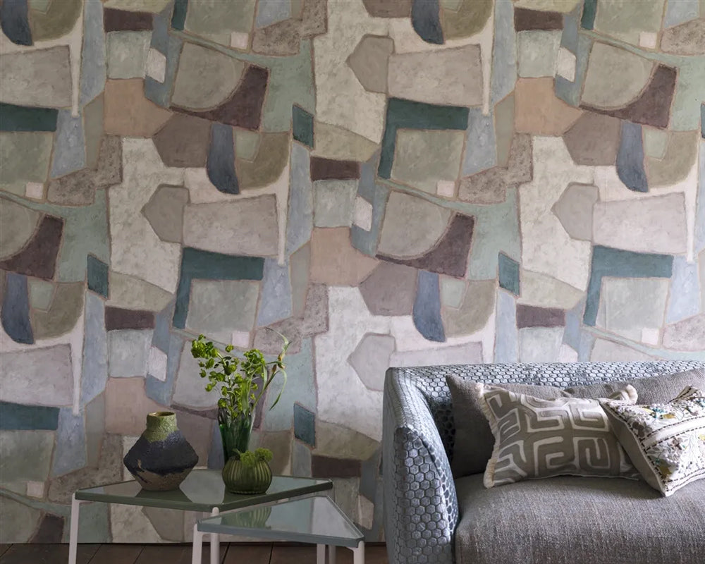 Living room with Designers Guild Clay Collage Wallpaper and a grey sofa.
