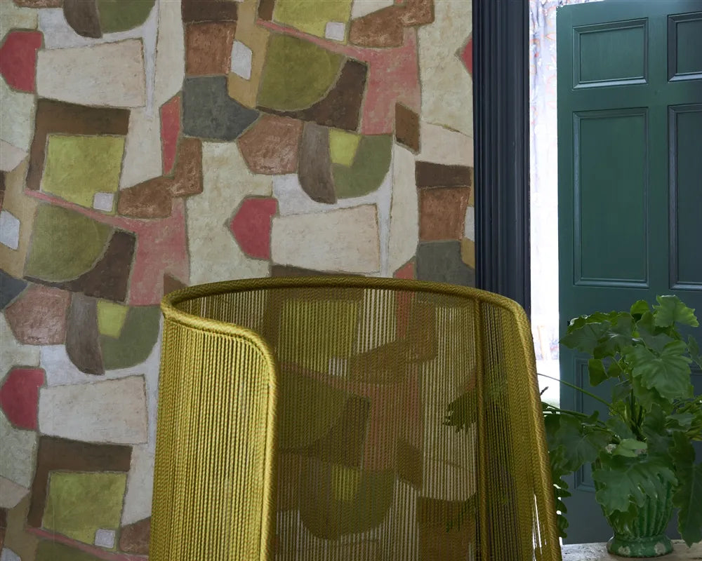 Yellow chair in front of Designers Guild Clay Collage Wallpaper