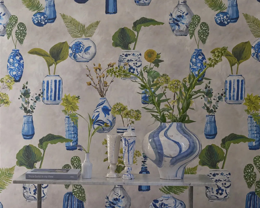 DesignersGuild Kawana Wallpaper with blue and white vases and green plants on a beige background