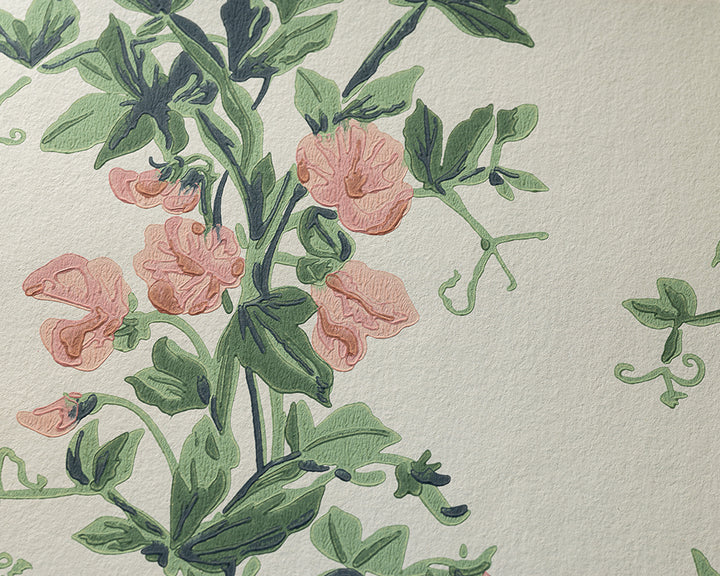 A close-up of floral wallpaper Sweet Paa, featuring green vines and leaves with pink flowers on a textured off-white background.