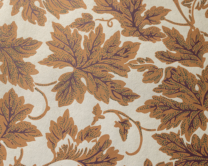 Farrow and Ball Vine Leaf - A close-up of a repeating botanical pattern featuring large tan and brown leaves with dotted detailing on a warm off-white background.
