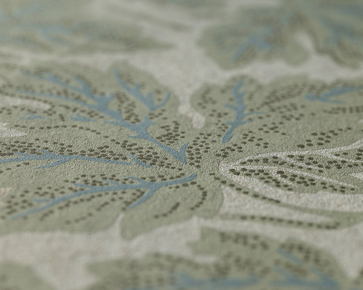 Farrow & Ball vine Leaf - Close-up of a textured wallpaper featuring a muted sage green and light blue botanical pattern on a warm off-white background.