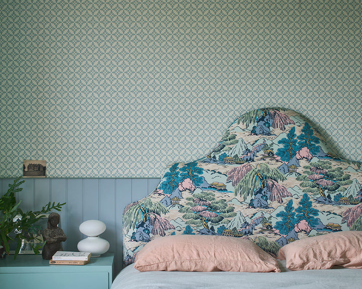 Farrow and Ball Achard Wallpaper 6403 behind a patterned bedhead