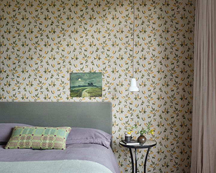 Farrow and Ball Auguste Wallpaper 6504 in a bedroom with artwork and side table