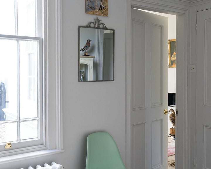 Blackened 2011 paint by Farrow & Ball in a hallway with chair and mirror