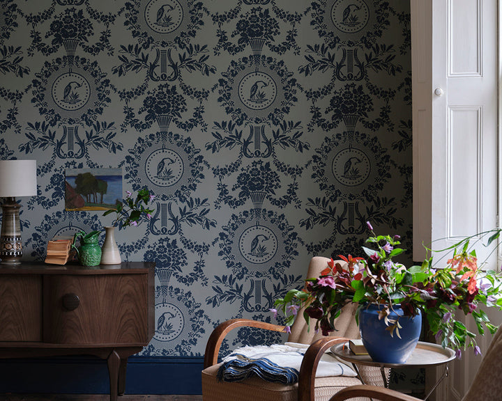 Farrow and Ball Purnon Wallpaper 6204 in a living room with chairs and plants