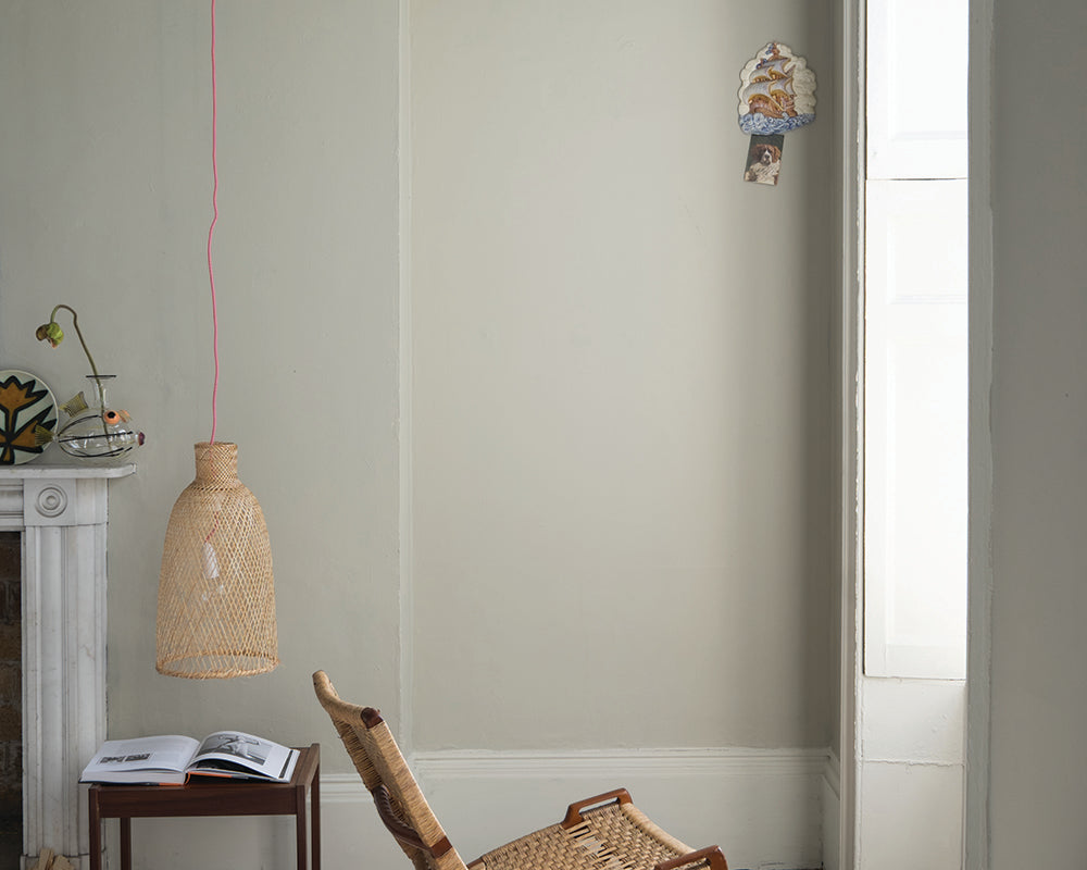 Shadow White 282 paint by Farrow & Ball in a living room with woven chair