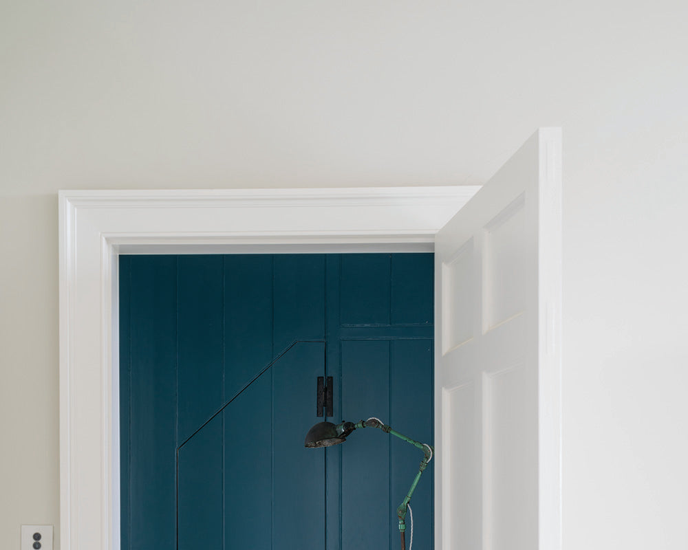 Strong White 2001 paint by Farrow & Ball in a room with a door