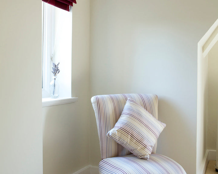 White Tie 2002 paint by Farrow & Ball in a hallway with a chair