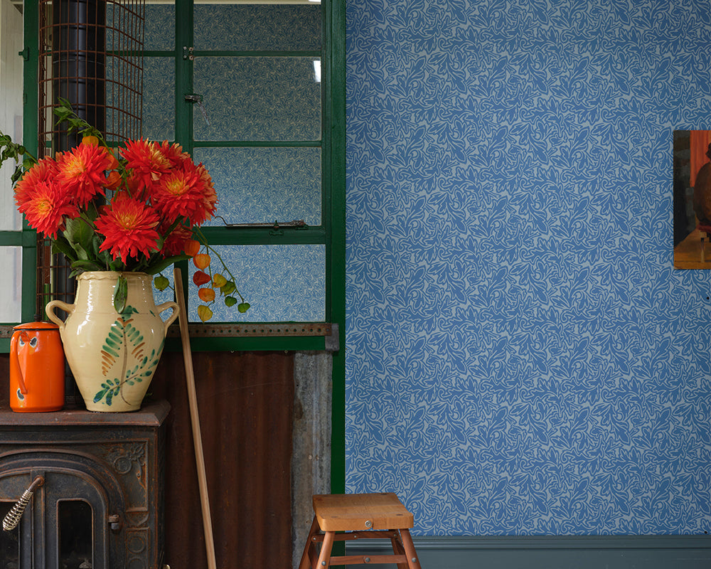 Farrow and Ball Feuille Wallpaper in a room with a stove