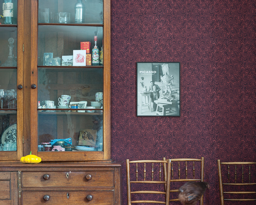 Farrow and Ball Feuille Wallpaper in room with a large cabinet and chairs