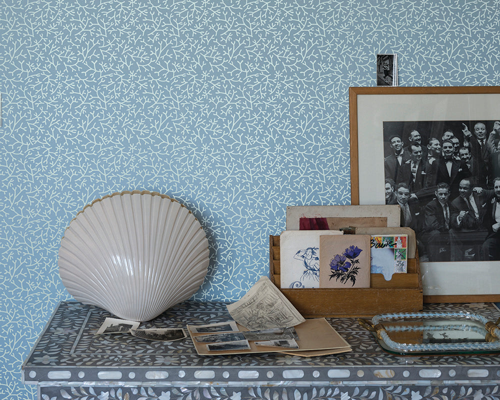 Farrow and Ball Samphire Wallpaper with a desk and ornaments