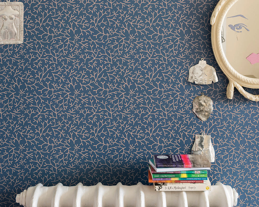 Farrow and Ball Samphire Wallpaper behind a cast iron radiator