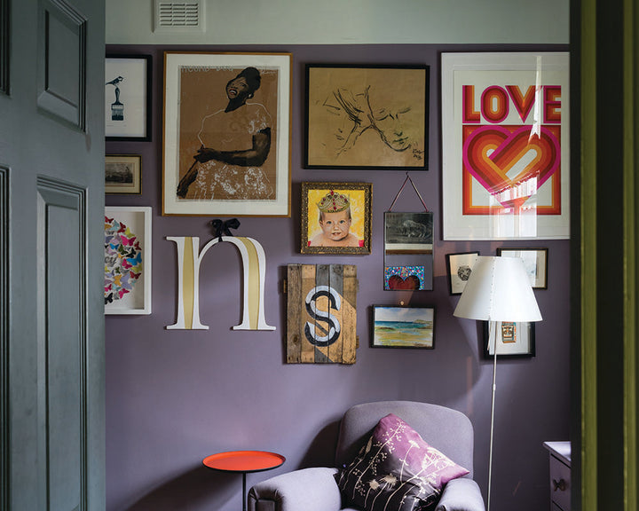 Brassica 271 paint by Farrow & Ball on the walls behind a quirky picture gallery