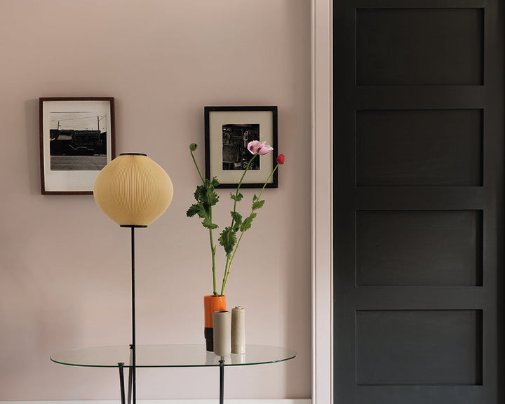 Peignoir 286 paint by Farrow & Ball on a wall next to a black door