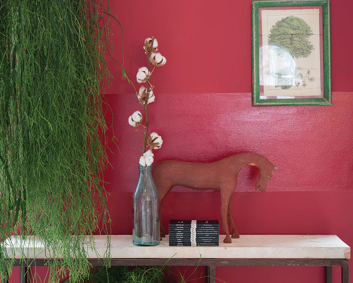 Rectory Red 217 paint by Farrow & Ball on the walls behind a side table