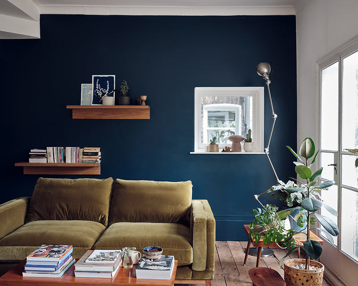 Hague Blue 30 paint by Farrow & Ball in a living room with green sofa