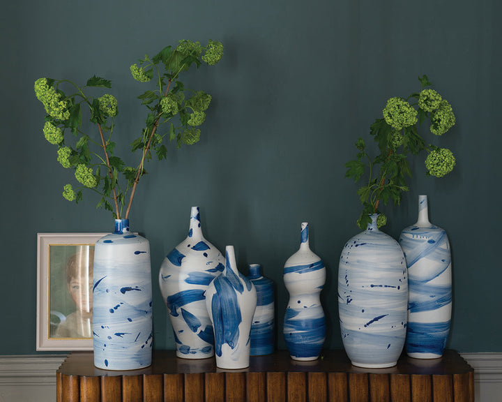 Inchyra Blue 289 paint by Farrow & Ball used on a wall with a display of vases