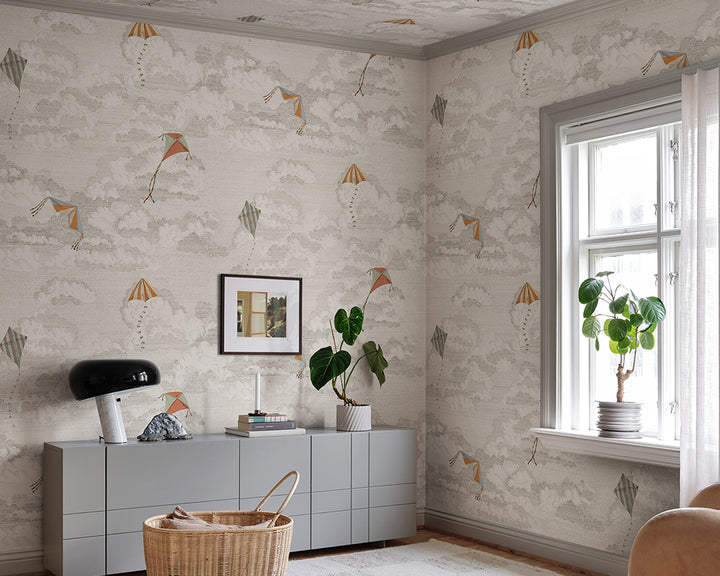 Modern interior with Sandberg Bonnie and Kites Mural Wallpaper, a grey cabinet, and decorative elements.