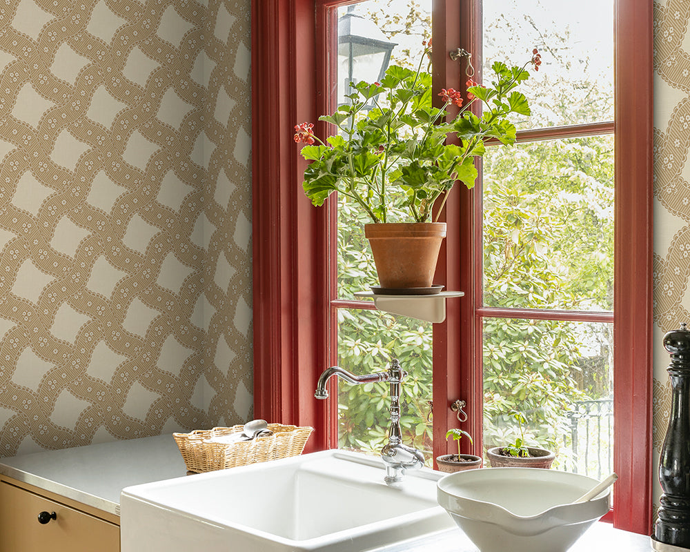 Kitchen sink area with a window, plants, and a patterned Sandberg Annie Wallpaper.