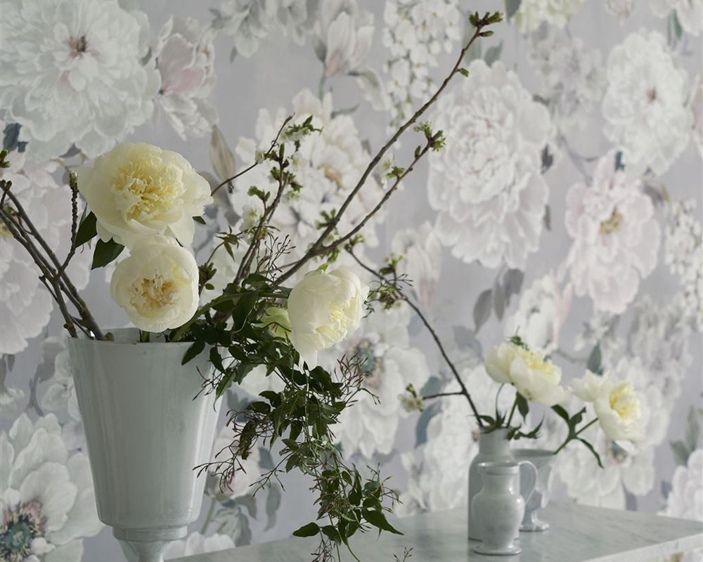 Designers Guild Fleur Blanche Wallpaper on a wall behind flowers