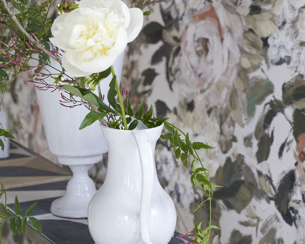 Designers Guild Fleurs D Artistes Wallpaper on a wall behind a table